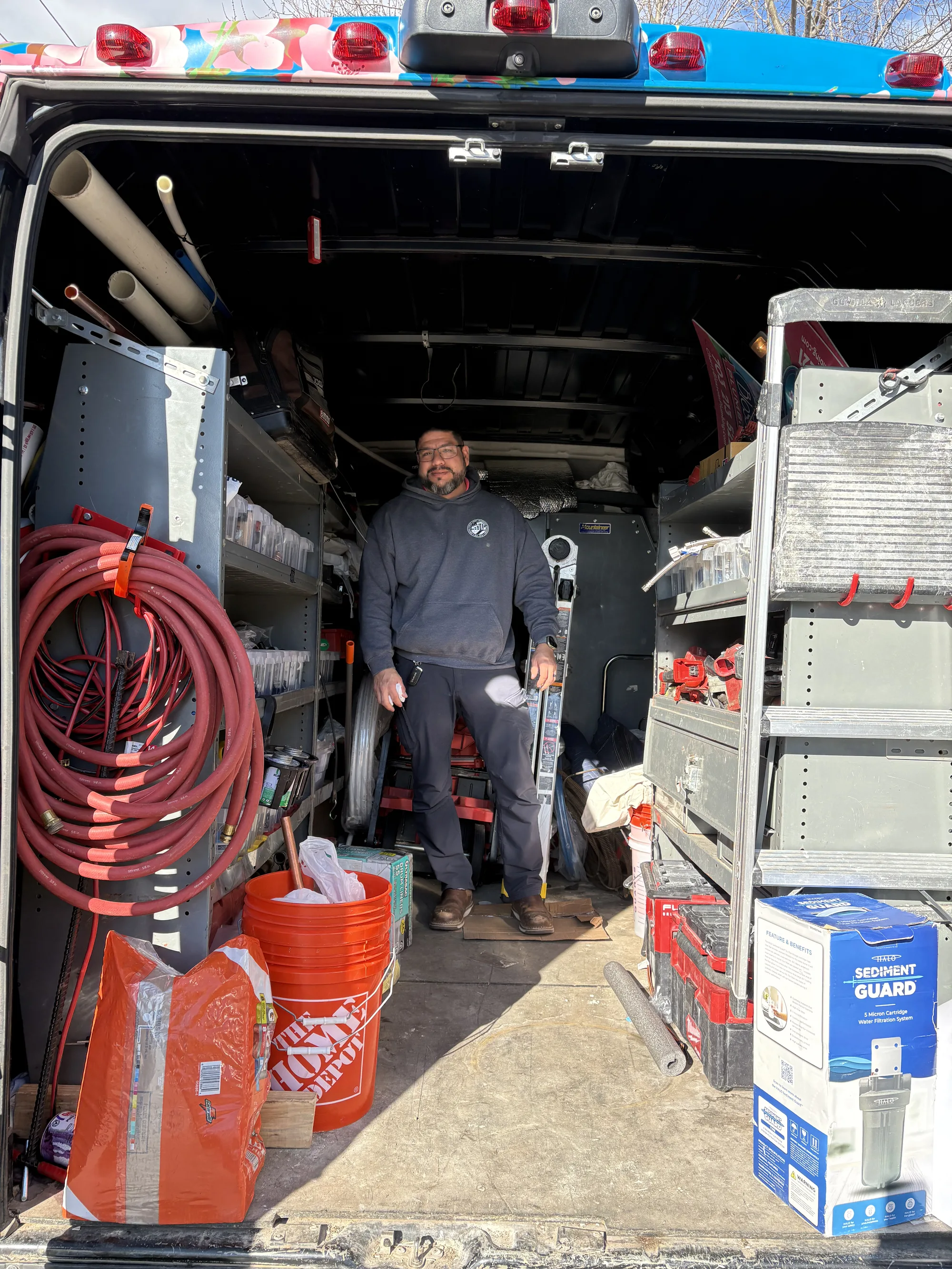 Cherry Blossom Plumbing technician smiling inside the service van